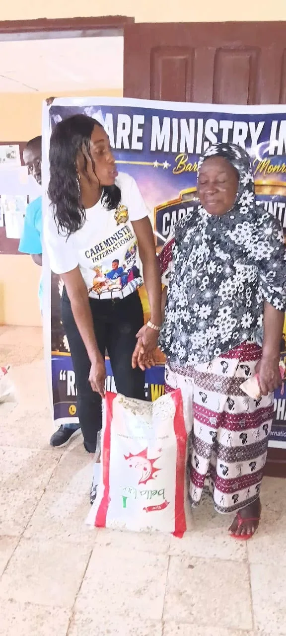 Ministry representative with a community member and food supplies