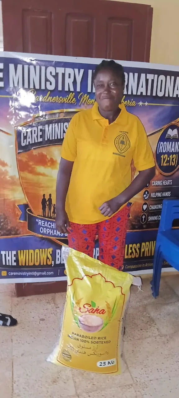 Community member standing with a bag of rice at a ministry outreach